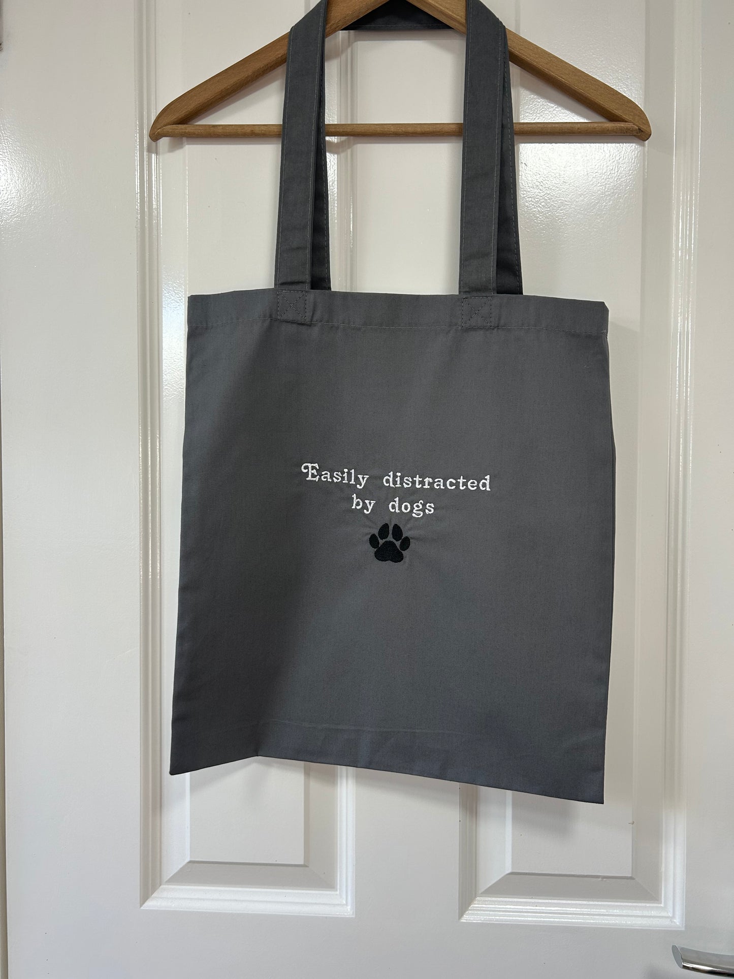 ‘Easily distracted by dogs’ tote bag